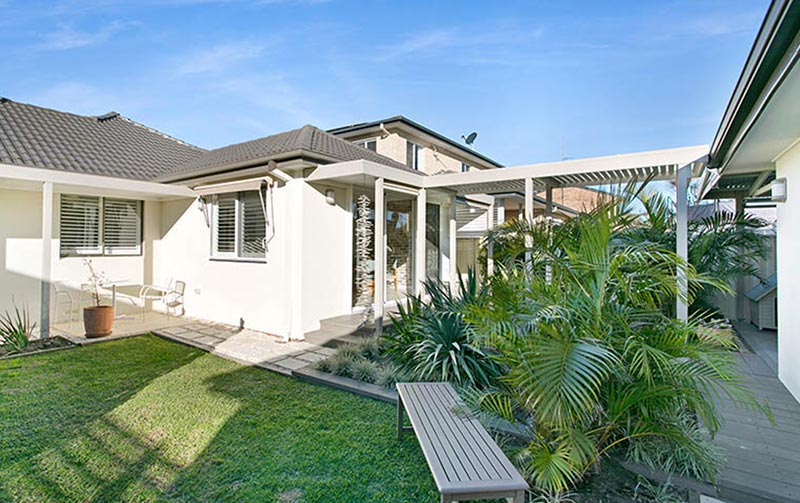 rendered home with walkway in multi-dwelling home